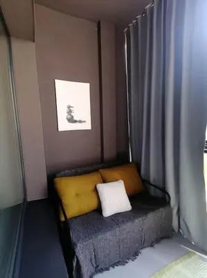 a small bed with a yellow pillow in a room at Erdvi studija Spacious studio apartment Self check in in Vilnius