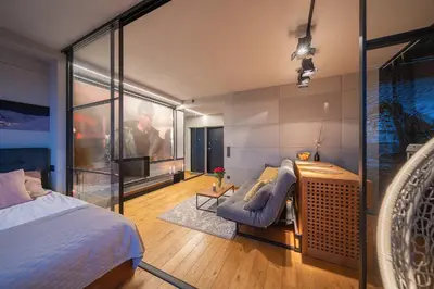 a bedroom with a bed and a desk and a chair at Vivulskio Apartament - Lollo Stay in Vilnius