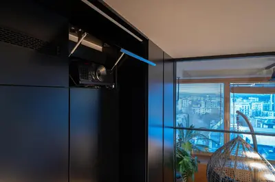 a kitchen with a refrigerator and a window at Vivulskio Apartament - Lollo Stay in Vilnius