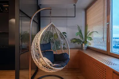 a hanging hammock chair in a room with a window at Vivulskio Apartament - Lollo Stay in Vilnius
