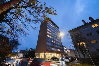 a tall building on a city street at night at Vivulskio Apartament - Lollo Stay in Vilnius