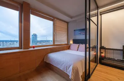 a bedroom with a bed and a large window at Vivulskio Apartament - Lollo Stay in Vilnius