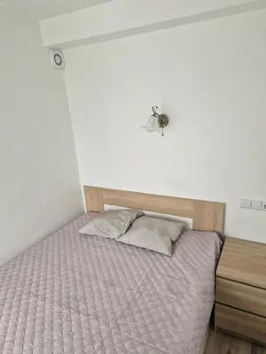 a bed in a bedroom with a tick on the wall at VYTAUTO 3 apartment in Ukmergė