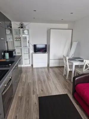 a kitchen and living room with a couch and a table at VYTAUTO 3 apartment in Ukmergė