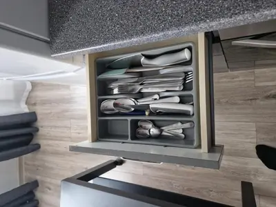 a drawer full of kitchen utensils sitting under a counter at VYTAUTO 3 apartment in Ukmergė