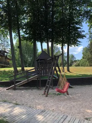 a playground with a swing and a hammock in a park at Vila Ula in Perloja