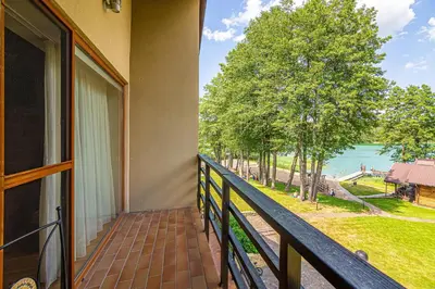 a balcony with a view of the water at Vila Ula in Perloja