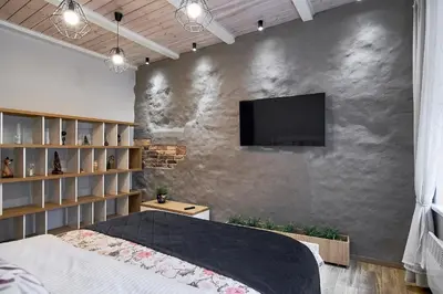 a bedroom with a wall with a tv on it at Cosy and authentic apartment in Vilnius Old Town in Vilnius
