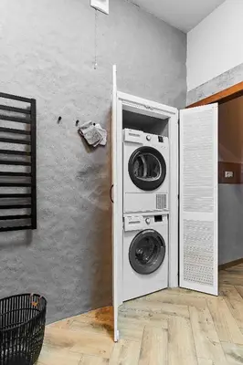a washer and dryer in a room with a wall at Cosy and authentic apartment in Vilnius Old Town in Vilnius