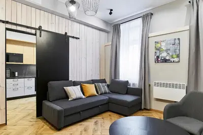 a living room with a couch and a table at Cosy and authentic apartment in Vilnius Old Town in Vilnius