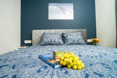 a tray of grapes on top of a bed at Fort63 house in Kaunas