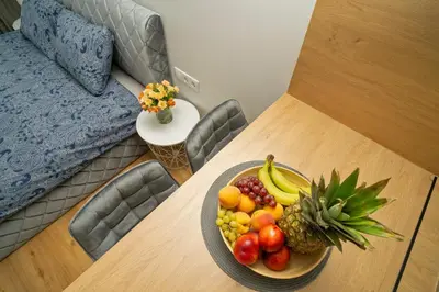 a bowl of fruit on a table in a room at Fort63 house in Kaunas