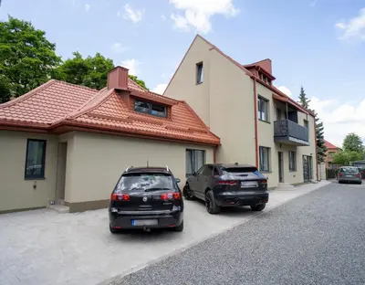 two cars parked in front of a house at Fort63 house in Kaunas