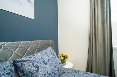 a bedroom with a couch and a vase of flowers at Fort63 house in Kaunas