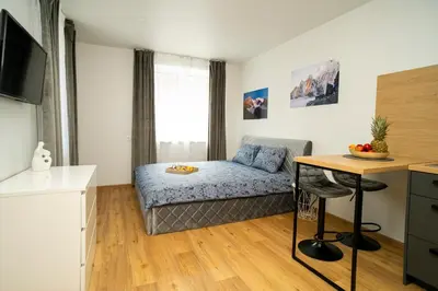 a small apartment with a bed and a table at Fort63 house in Kaunas