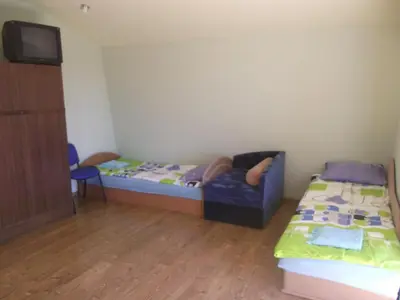 a small room with a bed and a couch at Nakvynė Rokiškyje in Rokiškis