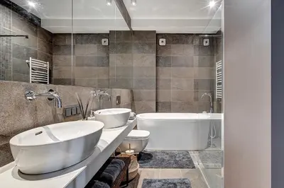 a bathroom with two sinks and a tub and toilet at Vilnius Apartments & Suites - Gedimino avenue in Vilnius