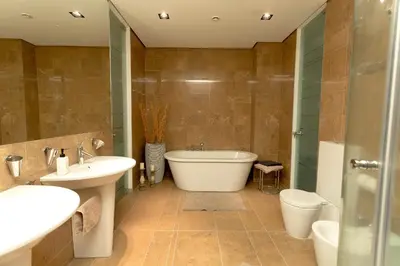 a bathroom with a tub and a sink and a toilet at Vilnius Apartments & Suites - Gedimino avenue in Vilnius
