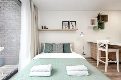 a bedroom with a bed and a desk at Paupys Central Apartments by Reside Baltic in Vilnius