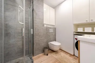 a bathroom with a shower and a toilet at Paupys Central Apartments by Reside Baltic in Vilnius
