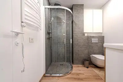a shower in a bathroom with a toilet at Paupys Central Apartments by Reside Baltic in Vilnius