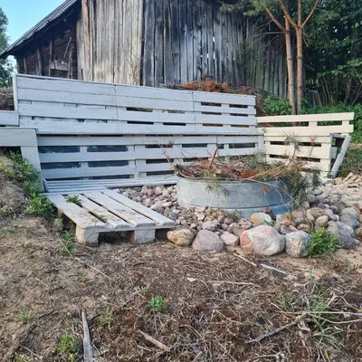 a wooden bench in front of a wooden building at Ramintos miško namelis in Žiogeliai
