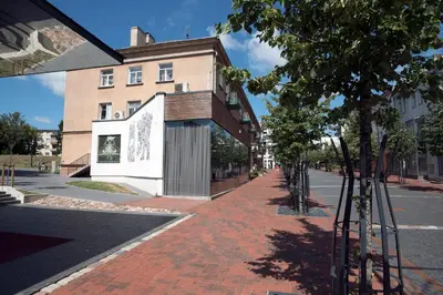 a red brick sidewalk in front of a building at Main Street Šiauliai, City Center in Šiauliai