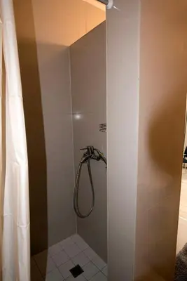 a bathroom with a shower with a shower curtain at Main Street Šiauliai, City Center in Šiauliai