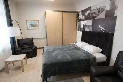 a hotel room with a bed and a chair at Main Street Šiauliai, City Center in Šiauliai