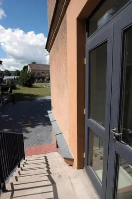 an entrance to a building with a glass door at Main Street Šiauliai, City Center in Šiauliai