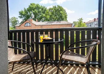 a table and two chairs on a balcony at Fort63 apartments in Kaunas