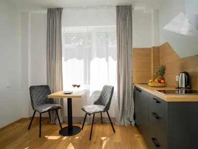 a kitchen with a table and two chairs and a window at Fort63 apartments in Kaunas