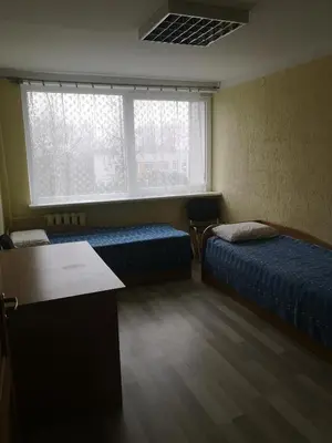 a room with two beds and a window at Kambarių nuoma Žeimelyje in Žeimelis