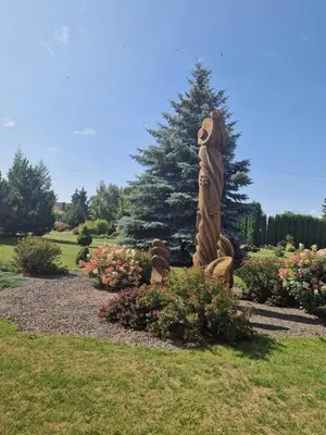 a statue of a woman standing in a garden at Kambarių nuoma Žeimelyje in Žeimelis