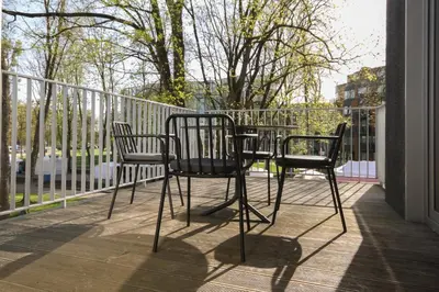 two chairs and a table on a balcony at Apartamentai Astra in Druskininkai