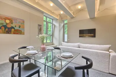 a living room with a glass table and a couch at Apartamentai Astra in Druskininkai