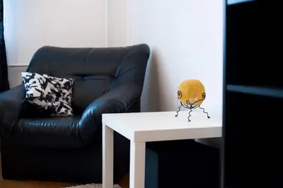 a living room with a chair and a table with a skull on it at V 13 - 3 BDR Balcony, Views - Courtyard n Vokiečių in Vilnius