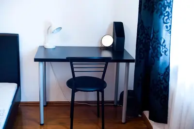 a blue desk with a chair and a speaker at V 13 - 3 BDR Balcony, Views - Courtyard n Vokiečių in Vilnius
