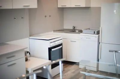 a white kitchen with a stove and a sink at V 13 - 3 BDR Balcony, Views - Courtyard n Vokiečių in Vilnius