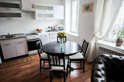 a kitchen with a table and chairs in a room at V 18 - Superior & Great views to Vokieciu street in Vilnius