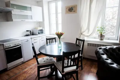 a kitchen with a table and chairs in a room at V 18 - Superior & Great views to Vokieciu street in Vilnius