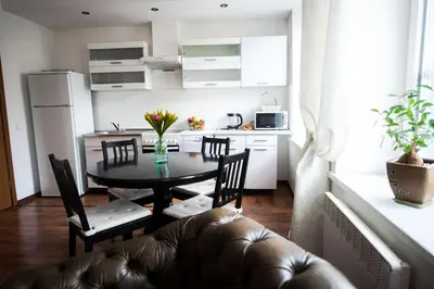 a living room with a table and chairs and a kitchen at V 18 - Superior & Great views to Vokieciu street in Vilnius