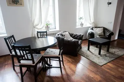 a living room with a table and chairs and a couch at V 18 - Superior & Great views to Vokieciu street in Vilnius