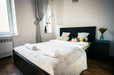 two beds in a bedroom with towels on them at V 18 - Superior & Great views to Vokieciu street in Vilnius