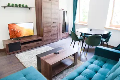 a living room with a blue couch and a table at Romantic New 1 Bedroom Vilnius Best Location in Vilnius