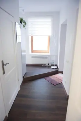 an empty hallway with a window and a door at Romantic New 1 Bedroom Vilnius Best Location in Vilnius