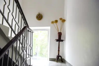 a staircase with a vase of flowers in a room at Romantic New 1 Bedroom Vilnius Best Location in Vilnius