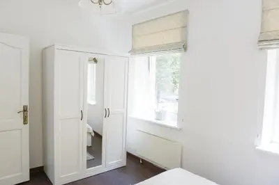 a white closet with a mirror and a window at Romantic New 1 Bedroom Vilnius Best Location in Vilnius