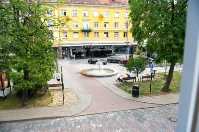 a city street with a fountain and a building at Romantic New 1 Bedroom Vilnius Best Location in Vilnius