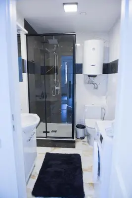 a bathroom with a shower and a toilet and a sink at Romantic New 1 Bedroom Vilnius Best Location in Vilnius